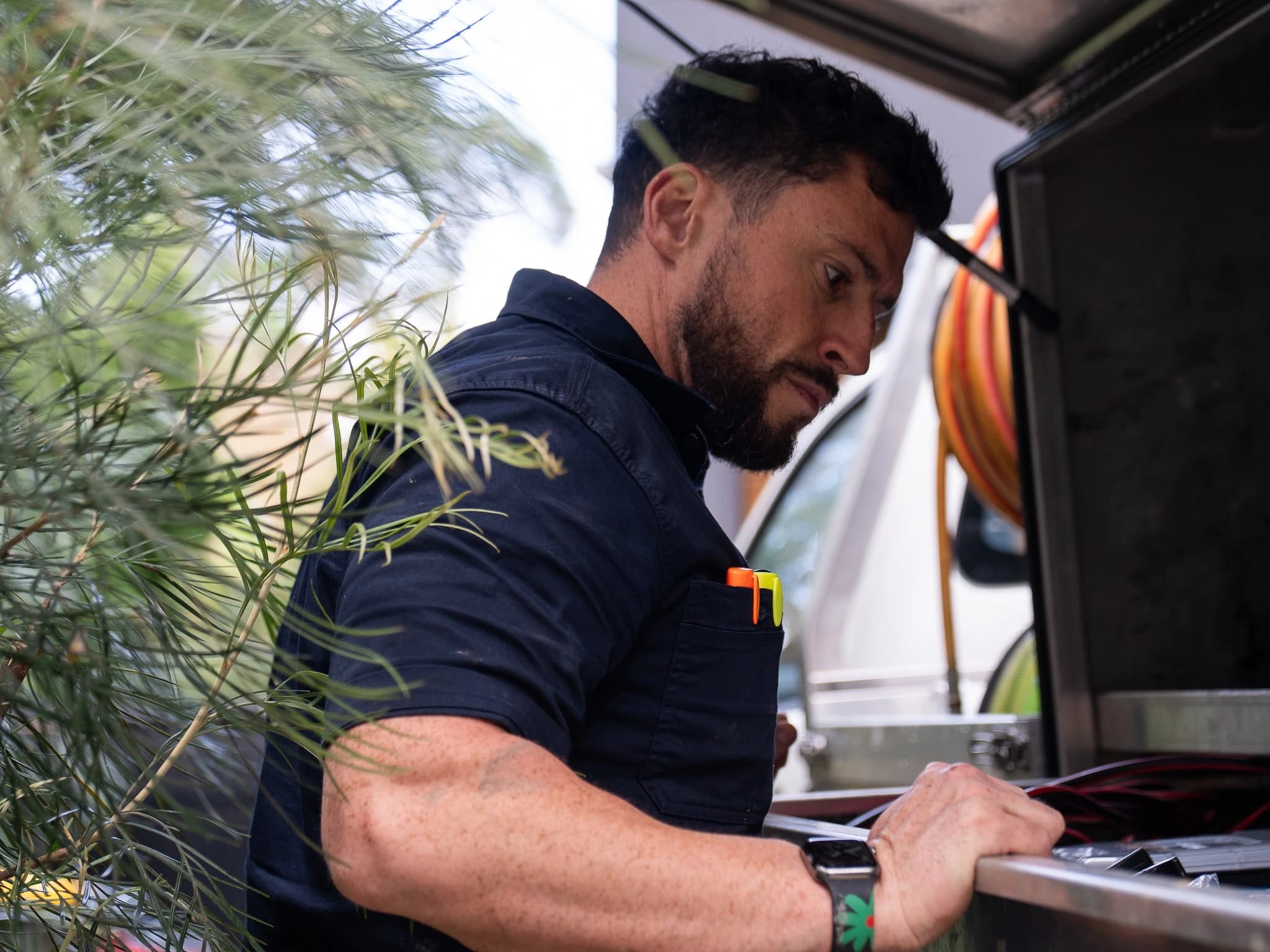 Tom Malone preparing equipment at the open TotalCare service vehicle